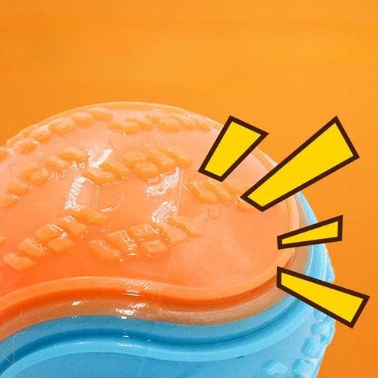 Close-up of a textured orange and blue object with yellow exclamation marks on an orange background