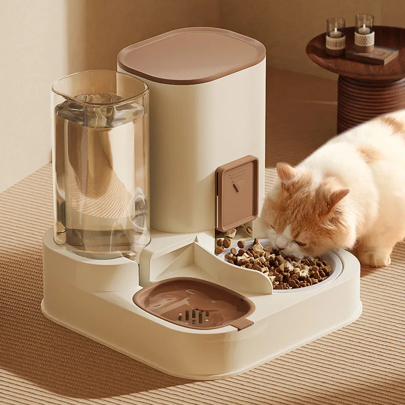 Pet feeding station with water dispenser and food bowl, cat eating from the bowl.
